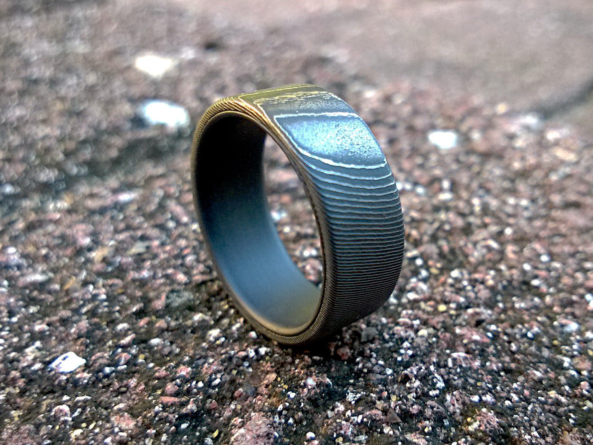 High contrast stainless damascus steel and matte black titanium men's wedding band