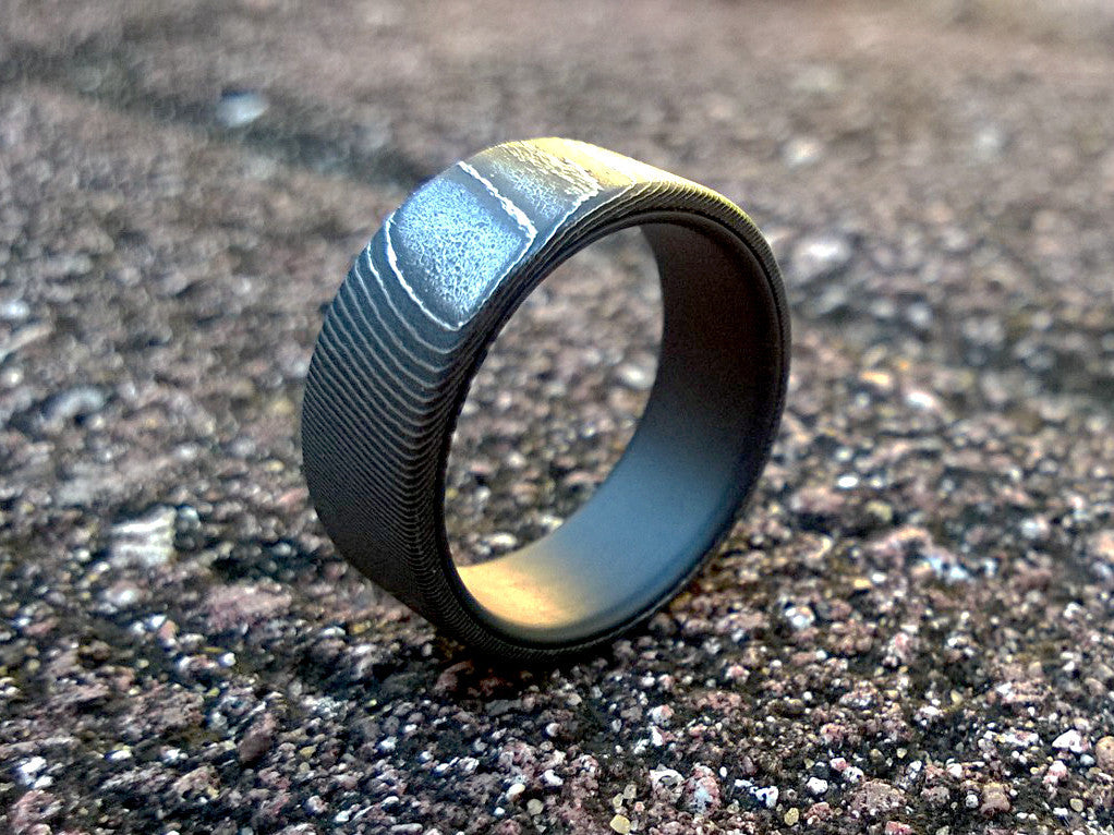 High contrast stainless damascus steel and matte black titanium men's wedding band