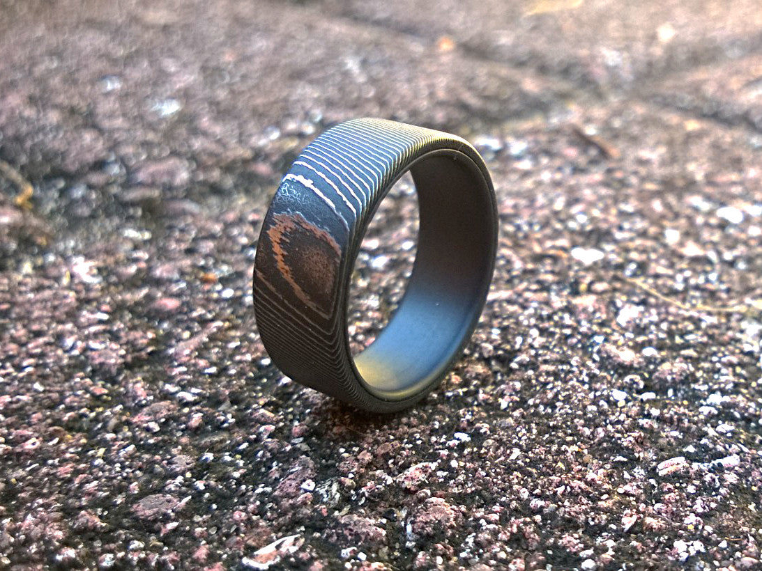 High contrast stainless damascus steel and matte black titanium men's wedding band